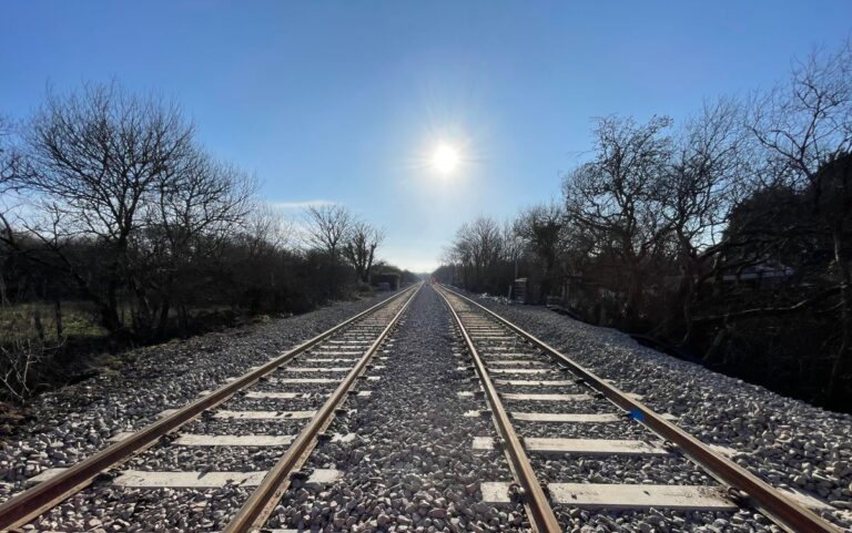 goss-moor-passing-loop Railway tracks side by side at Goss Moor, with sun overhead